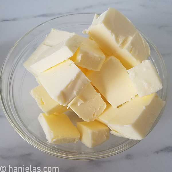 Chunks of butter in a glass bowl.