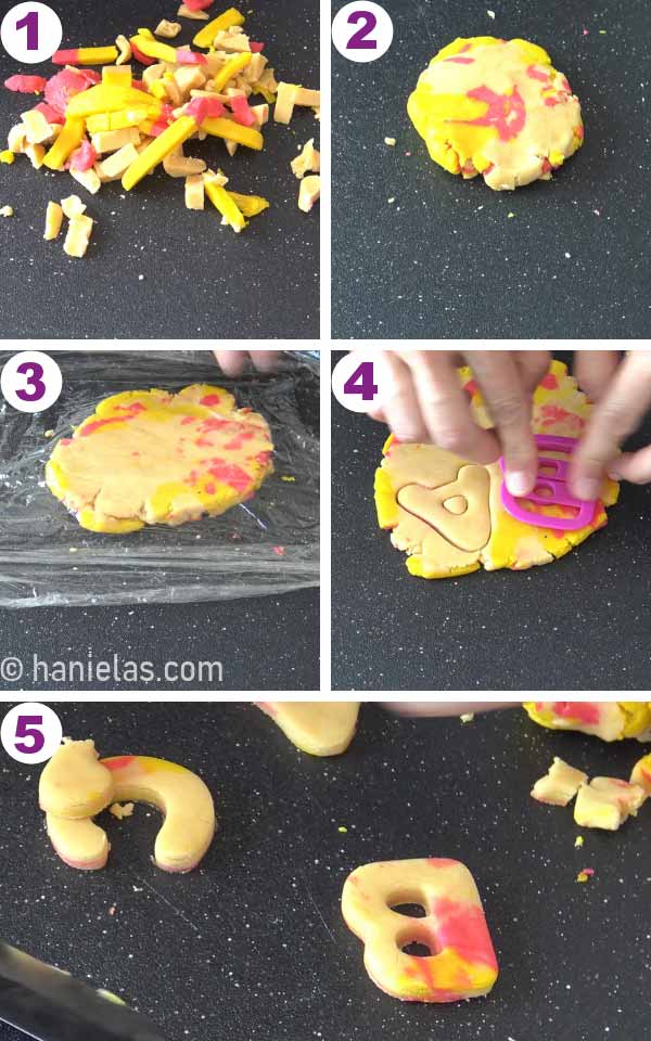 Rolling out marbled cookie dough and cutting out letter cookies.