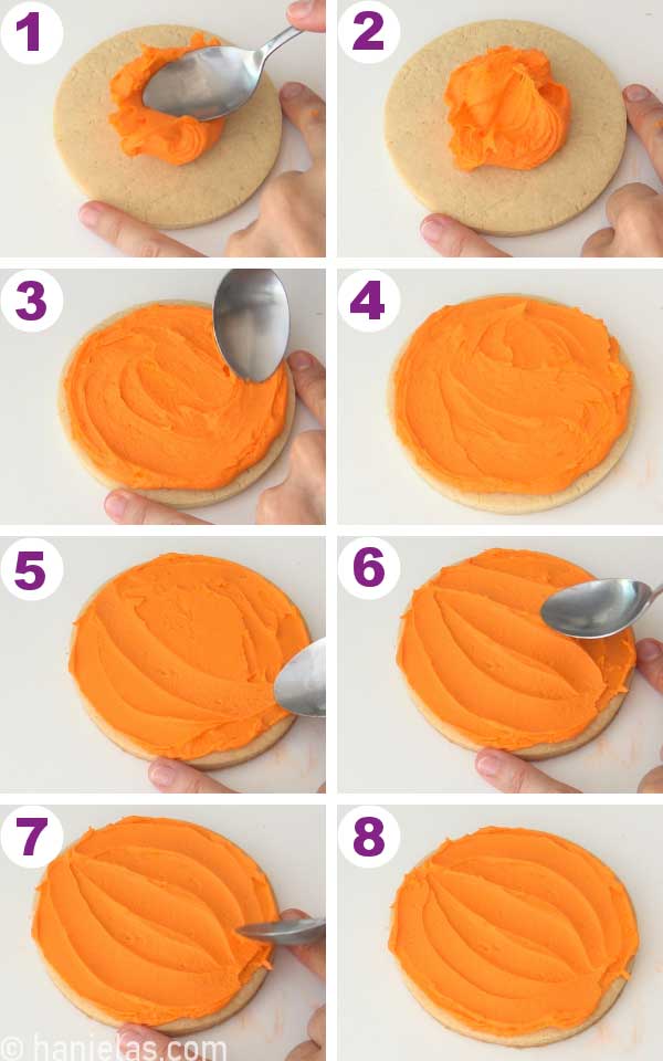 Spreading orange buttercream onto a round cookie with a spoon.
