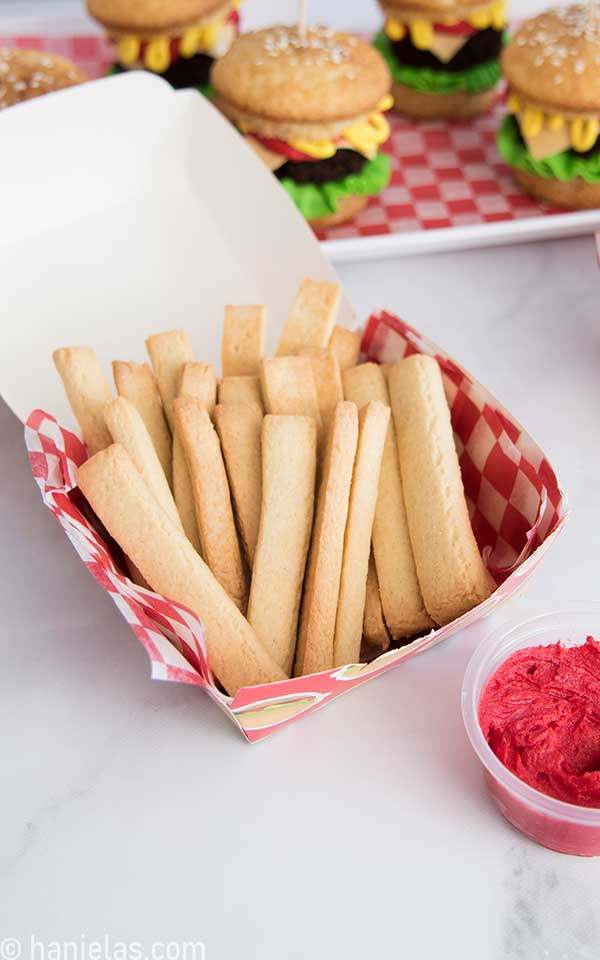 Cookie fries in a paper box lined with a red and white checkerboard paper.