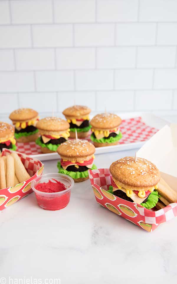 Decorated cupcakes, and cookie fries on a table.