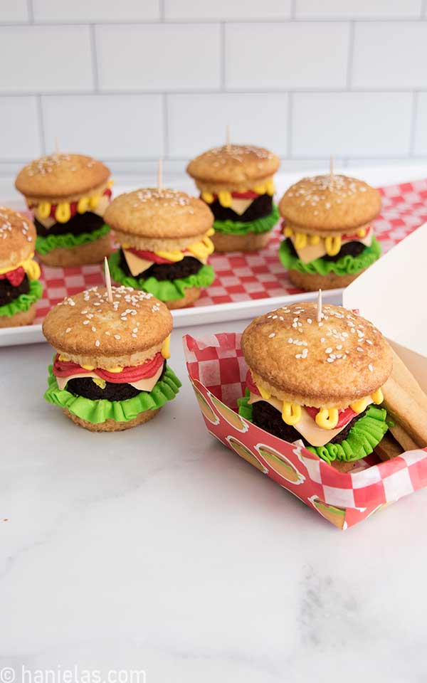 Cupcakes filled with a brownie, buttercream and fruit candy displayed on a table..