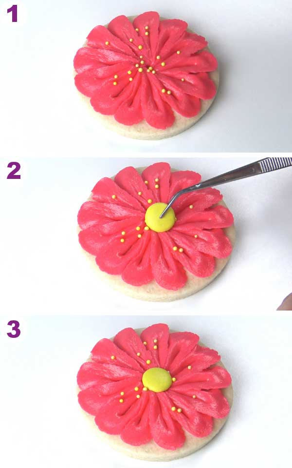 Tweezer holding yellow candy and pressing it onto the buttercream cookie.