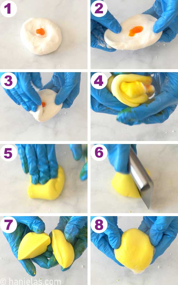 Two hands folding yellow gel color into white fondant.