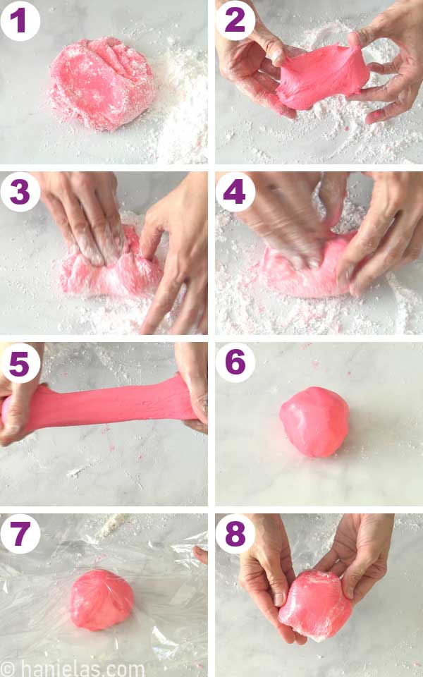 Kneading pink fondant on a surface dusted with powdered sugar.