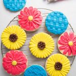 View from the above, of several round cookies decorated with buttercream.