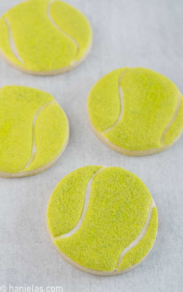 Decorated round cookies that look like tennis balls.