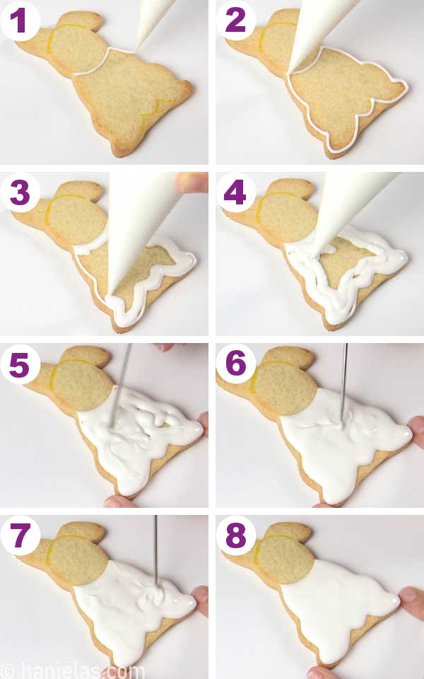 Piping white icing onto a bottom part of the sitting bunny cookie.