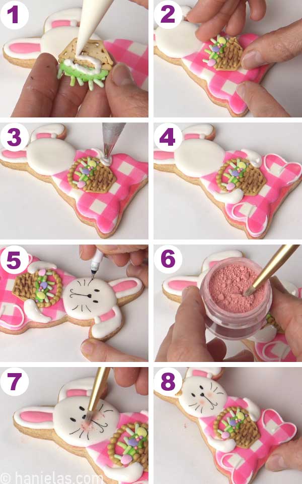Hand holding a small royal icing easter basket, gluing it onto a cookie.