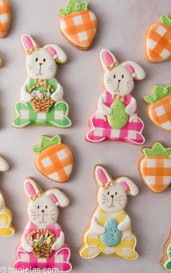 Colorful sitting bunnies cookies decorated with royal icing.