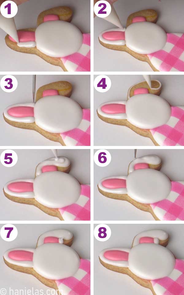 Piping ears on a bunny with white icing.
