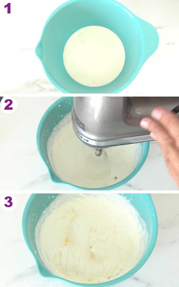 Whipped cream in a blue bowl, hand beating whipped cream with a handheld mixer.