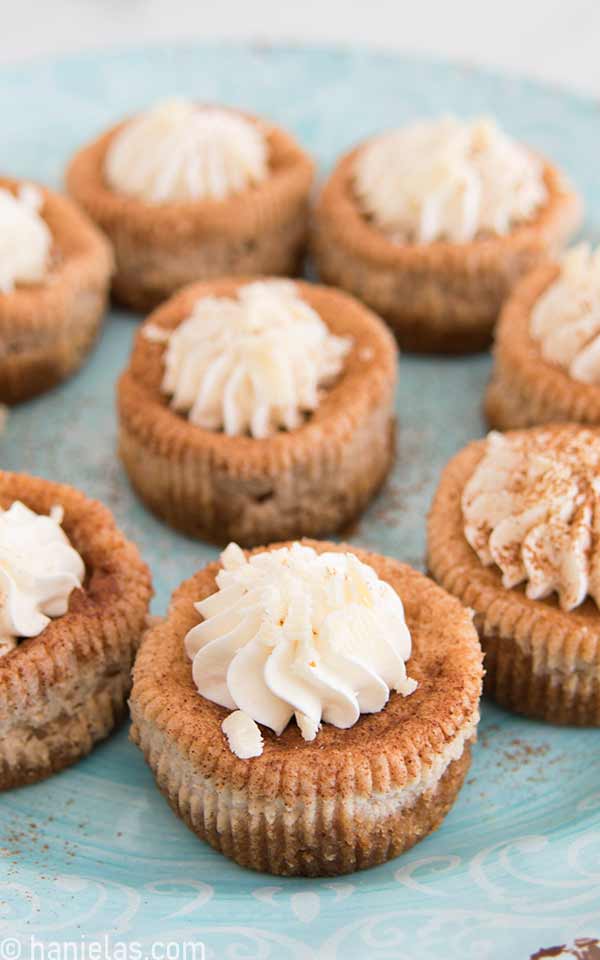 Mini cakes decorated with whipped cream swirl and chocolate shavings.