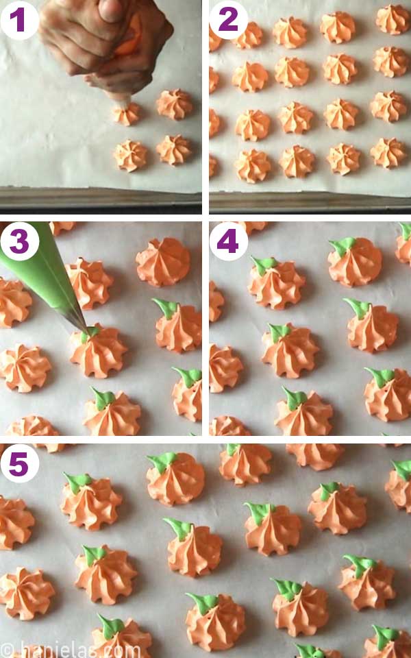 Baking sheet with parchment and piped orange and green meringue cookies.