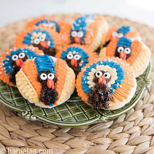 Buttercream decorated cookies on a plate.