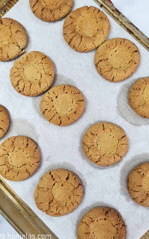 Golden brown cookies on a baking sheet lined with parchment.