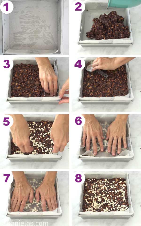 Square pan filled with cookie chocolate filing, hands pressing down the filling.