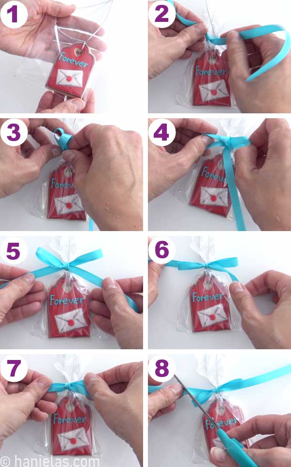 A red cookie in a poly bag with a teal bow.