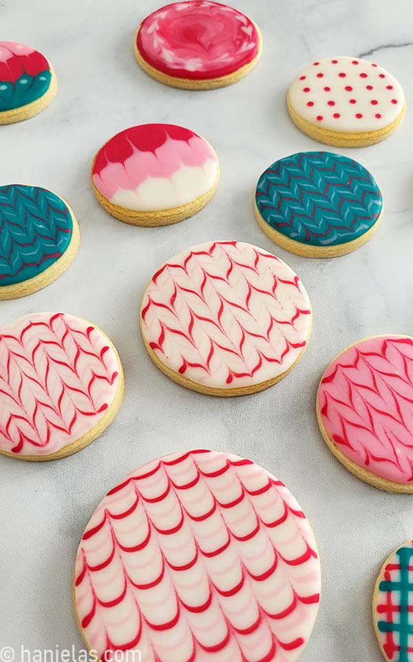 Close-up of a round cookie decorated with white and red icing.