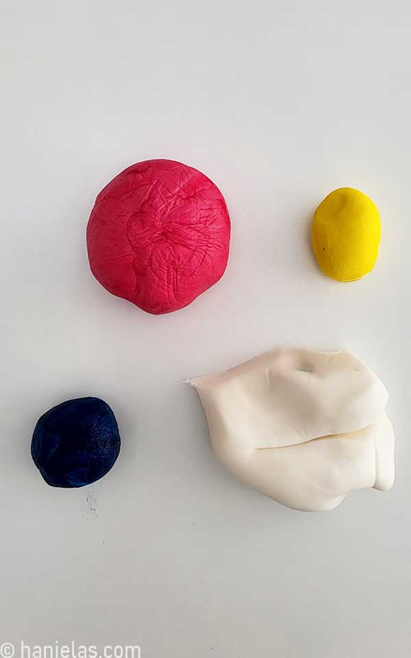 Pink, yellow, blue and white fondant pieces.