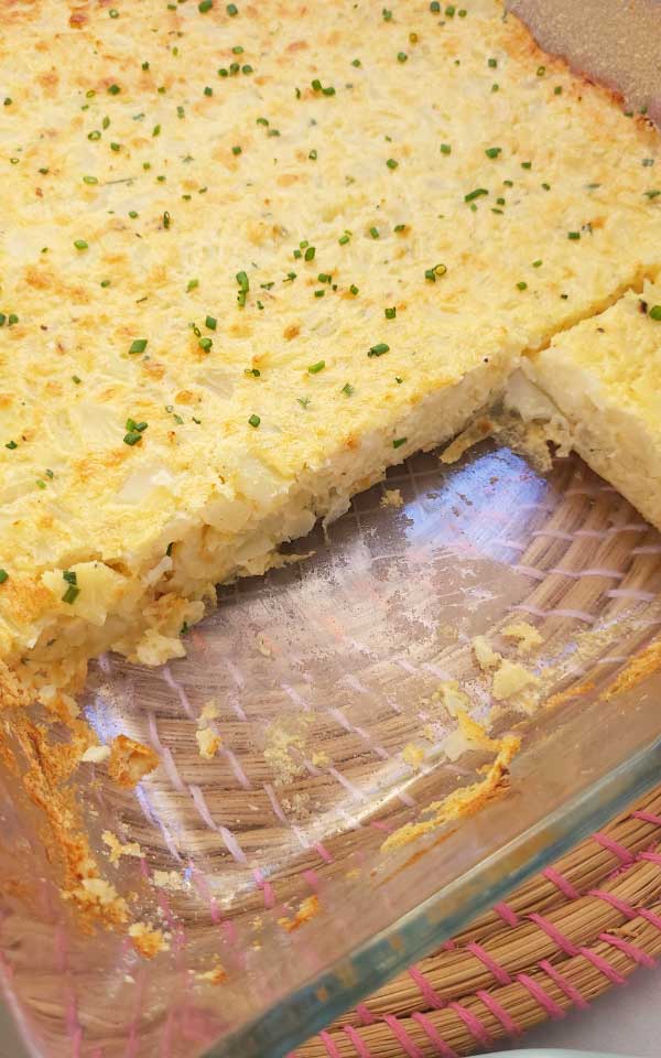 Detail of a sliced vegetable casserole in a glass baking pan.