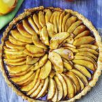 A view from above, a round tart filled with apple slices in caramel.