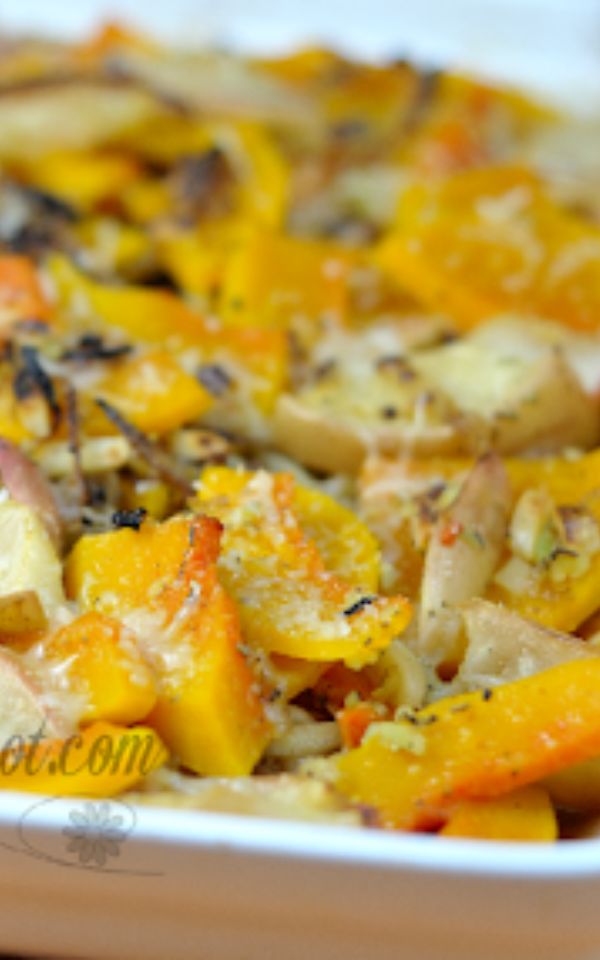 A close up of baked orange squash in a white pan.