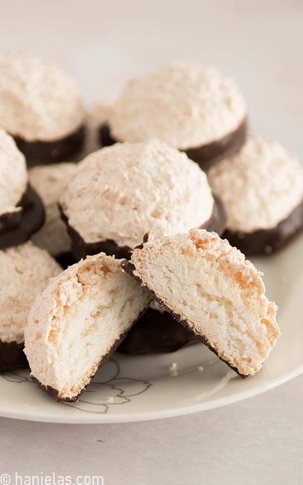 Cookies stacked on a plate with one cookie cut in half.