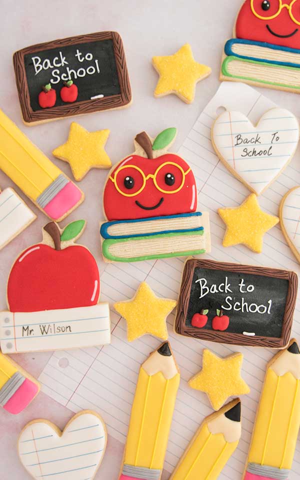 An assortment of decorated back to school themed cookies.
