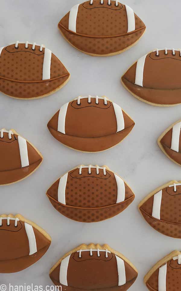 A birds few of decorated cookies in a shape of a football.