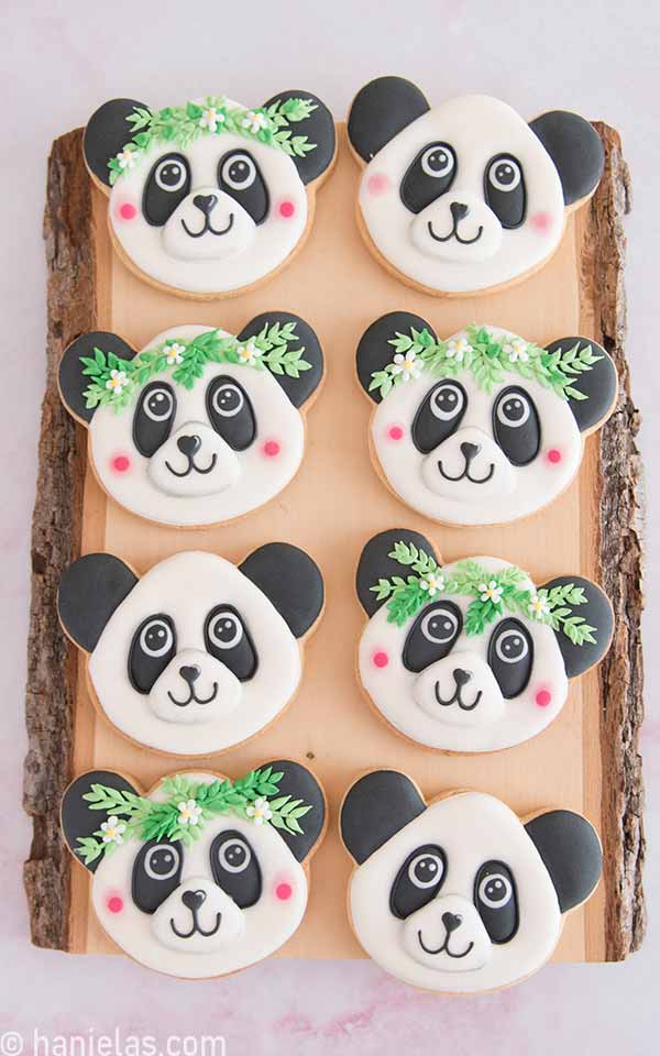 Decorated cookies displayed on a wood board.