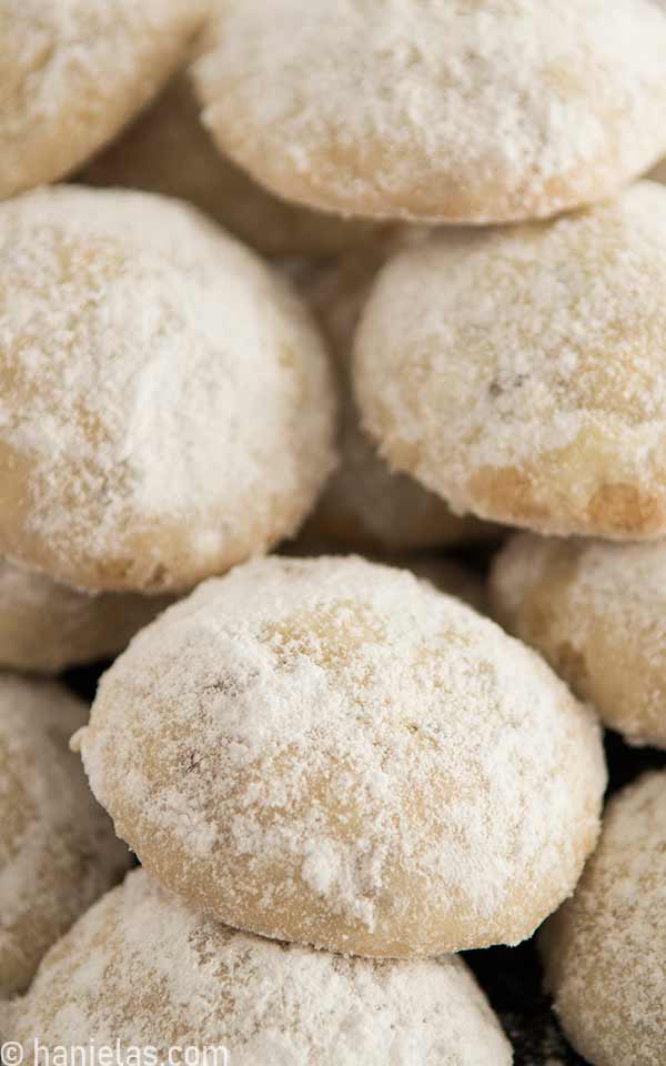 A close of cookies dusted with powdered sugar.