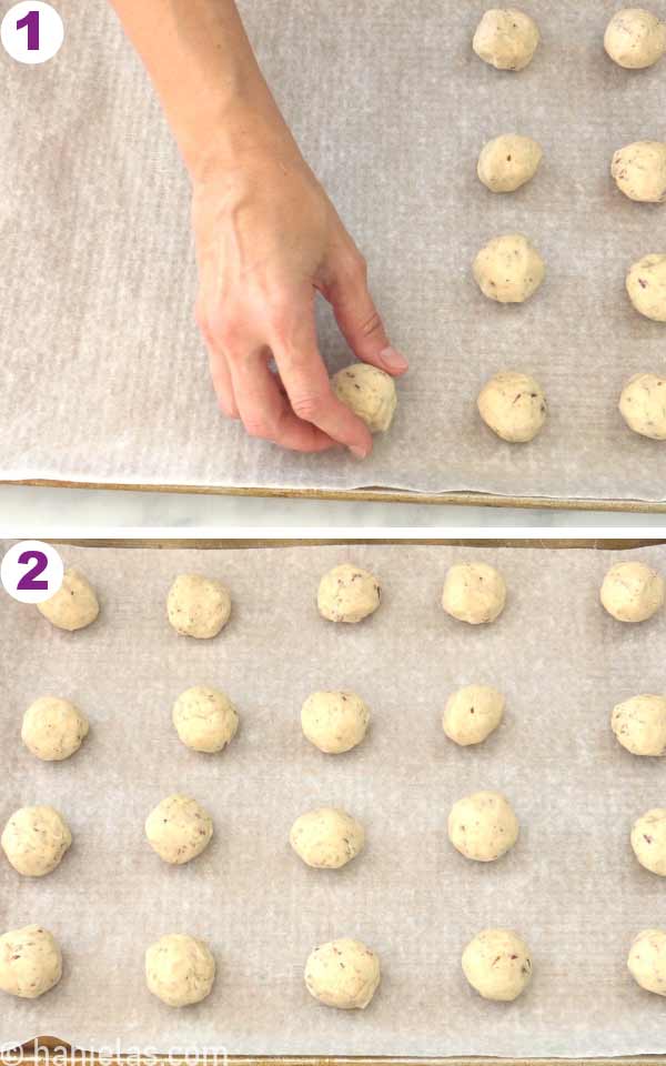 A baking sheet lined with parchment and balls of cookie dough on the baking sheet.