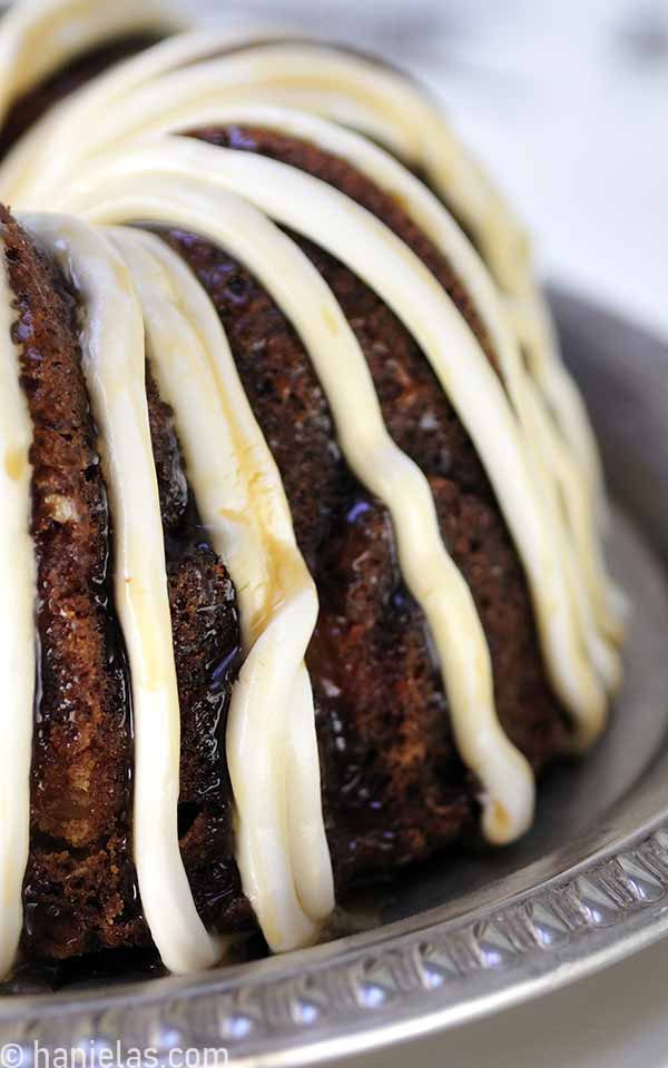 A side of Bundt cake with a frosting drizzle.