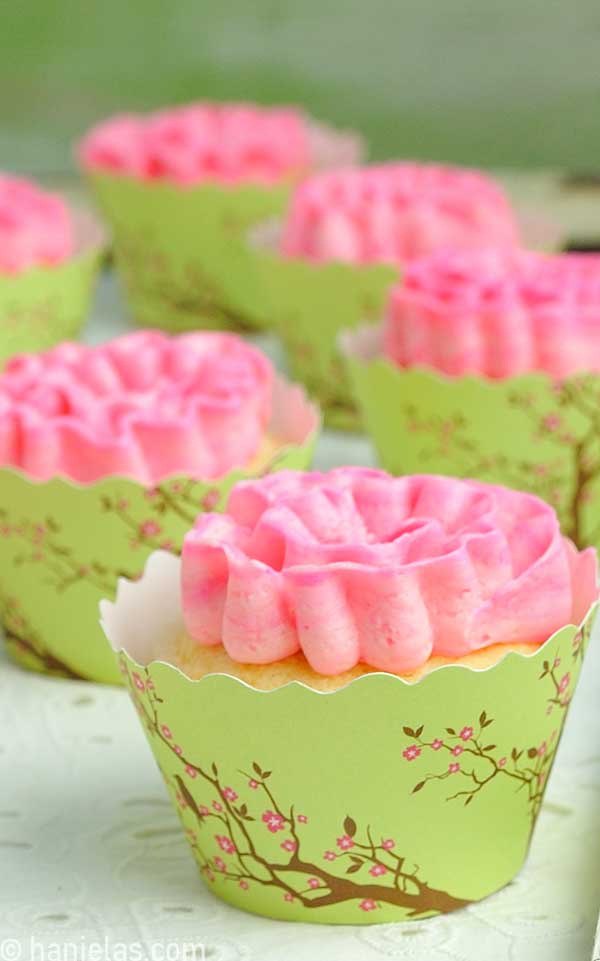 A close-up of buttercream ruffled ribbon rose.