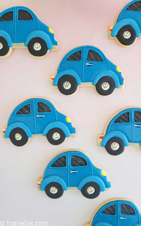 Decorated cookies are arranged on a bokeh background.