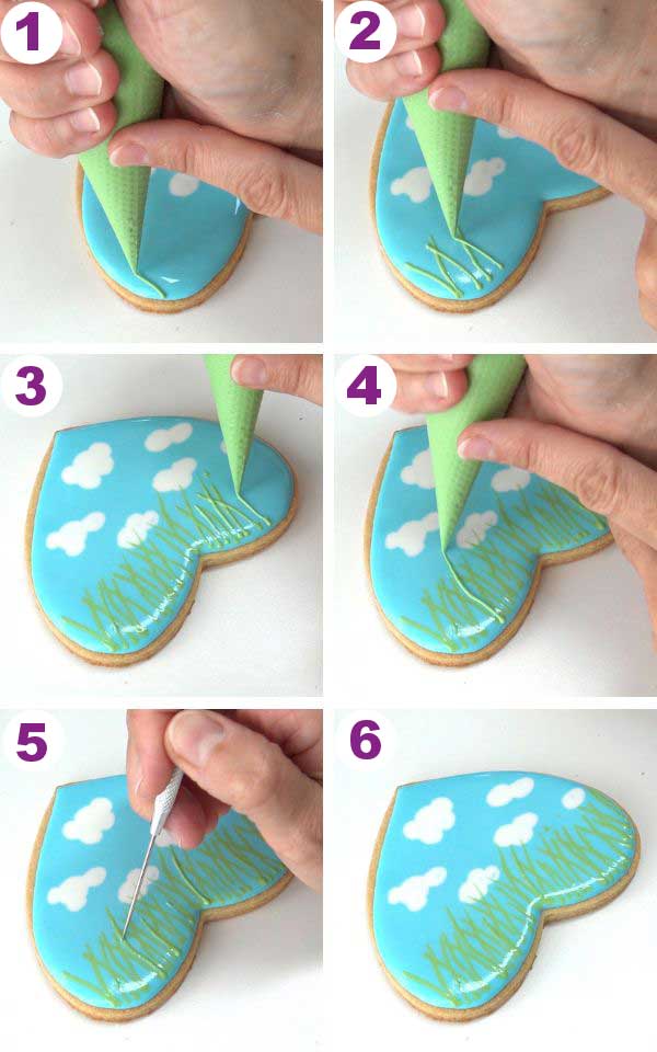 Piping green lines with icing onto the wet blue icing.