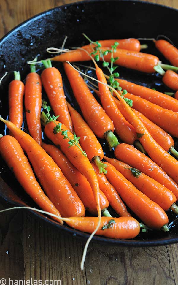 Fresh carrots in a cast iron pan.