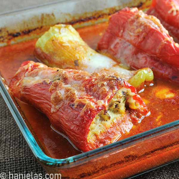 Close-up of roasted stuffed peppers filling in a casserole dish.