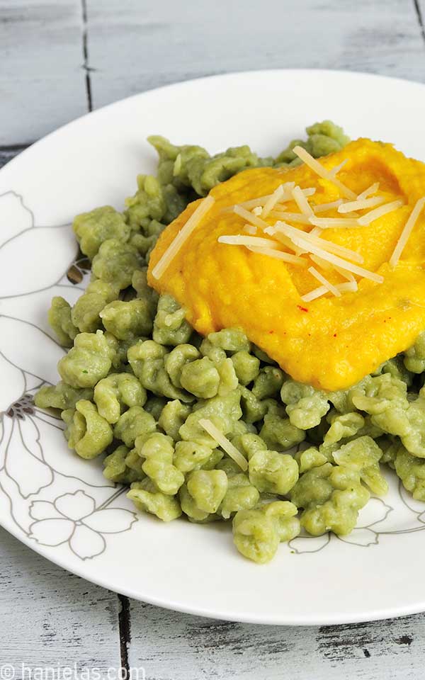 Green dumplings with orange sauce.