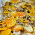 Baked sliced squash with marinade, apples, cheese and nuts.