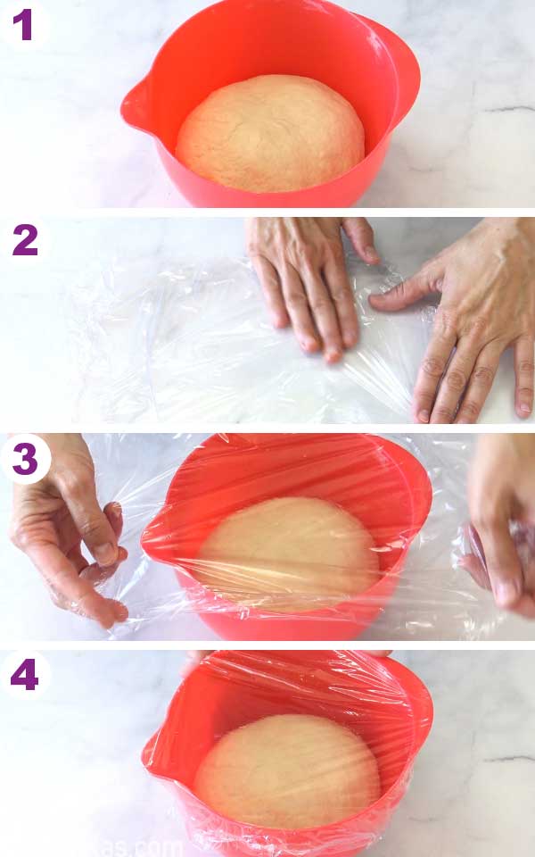 Bowl with dough covered with plastic wrap.