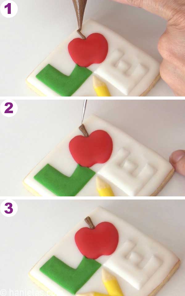 Piping a brown stem on an apple.