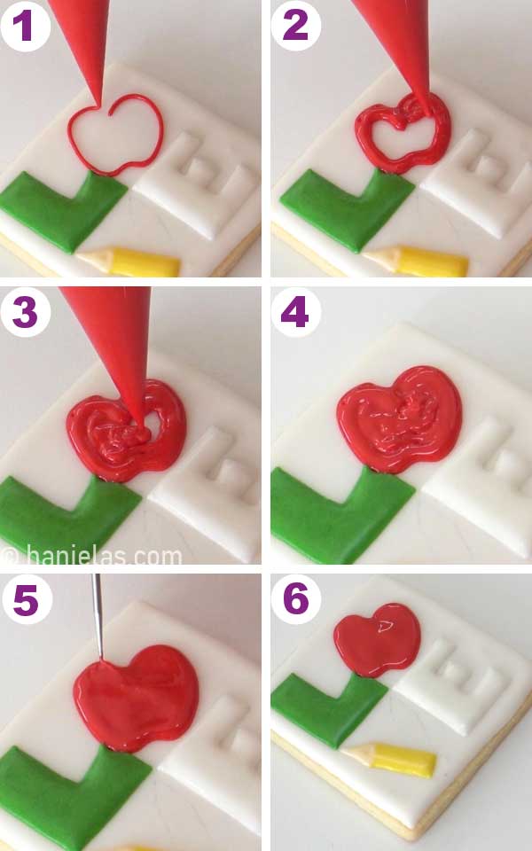 Outlining and flooding apple shape with red icing.