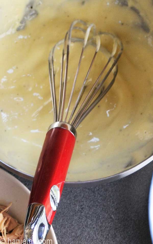 Homemade mayonnaise in a stainless steel bowl.