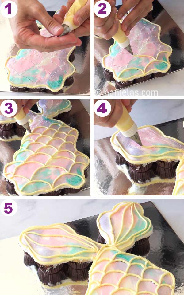 Piping bag piping mermaid scales onto a cake.
