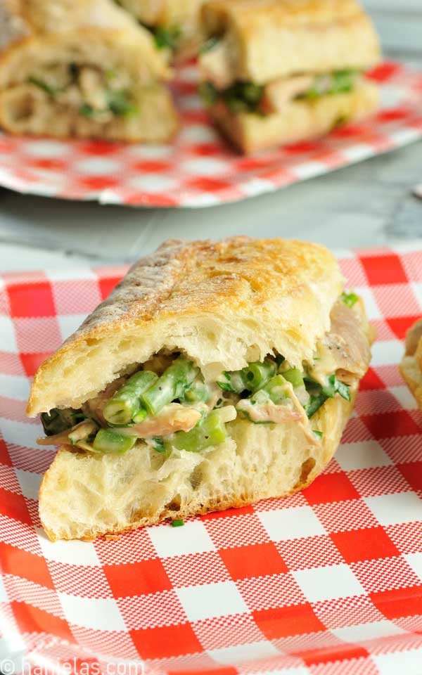 Close-up of baguette sandwich filled with a salad.