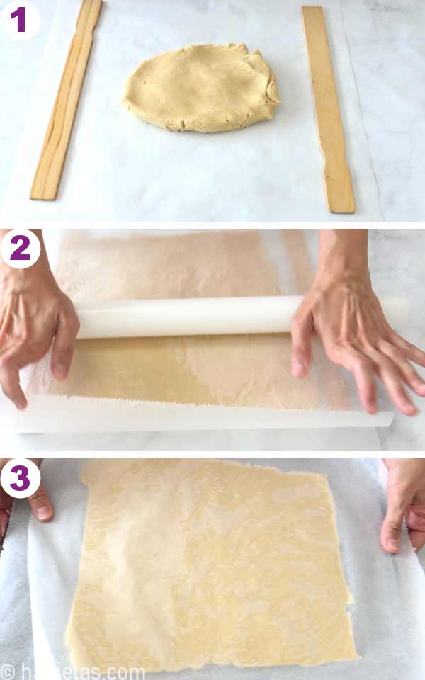 Rolled out cookie dough between two parchment sheets.