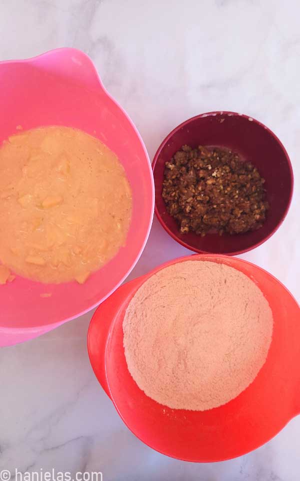 Three mixing bowls with ingredients.