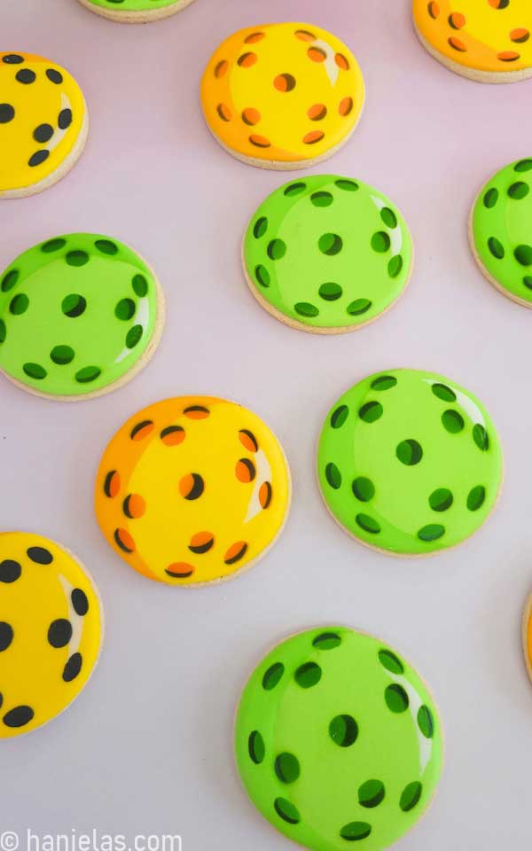 View from the above, round cookies decorated with royal icing that look like pickleball.